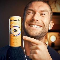 Image of man smiling holding Neutonic beverage