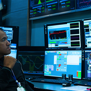 Image of man looking at computer monitors