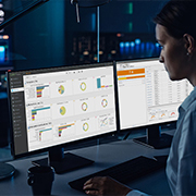 Image of woman monitoring security on multiple desktops