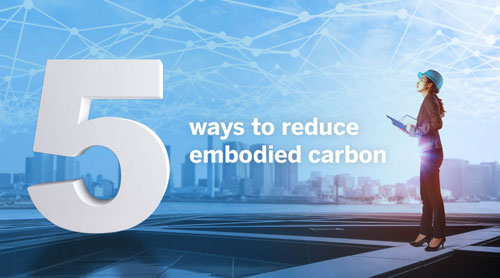 Image of a woman worker on a rooftop with words: 5 ways to reduce embodied carbon 