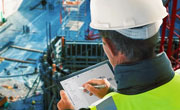 Image of construction worker writing on clipboard