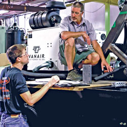 Men talking while standing on truck