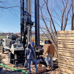Men working with drilling rig