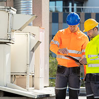 Image of workers looking at unit